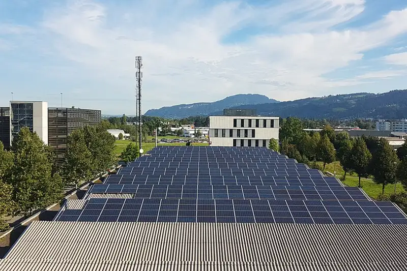 Large rooftop solar array covering a factory building